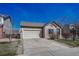 Brick ranch home with attached garage and landscaped yard at 15119 E 119Th Ave, Commerce City, CO 80603