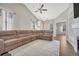 Spacious living room with vaulted ceiling, fireplace and large sectional sofa at 15119 E 119Th Ave, Commerce City, CO 80603