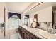 Bathroom with marble countertops, a makeup mirror, and great lighting at 3633 S Ingalls St, Denver, CO 80235
