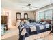 Spacious bedroom with ceiling fan and ample natural light from the window at 3633 S Ingalls St, Denver, CO 80235