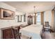 Bright dining room with a covered table, elegant chandelier, and natural light from the windows at 3633 S Ingalls St, Denver, CO 80235