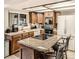 Well-equipped kitchen with wooden cabinets, granite countertops, and stainless steel appliances at 3633 S Ingalls St, Denver, CO 80235