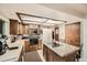 Bright kitchen featuring wood cabinets, central island with cooktop, and modern appliances at 3633 S Ingalls St, Denver, CO 80235