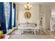 Elegant dining area featuring a rustic table, bench seating, and stylish chandelier at 3214 S Bahama St, Aurora, CO 80013