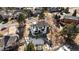 An aerial view showing the large yard with play equipment surrounded by mature trees at 6367 Arapahoe Ct, Parker, CO 80134