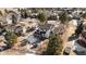 Aerial view of the backyard featuring recreational equipment, mature trees, and partial snow cover in the landscape at 6367 Arapahoe Ct, Parker, CO 80134