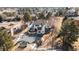Enjoy the view from above of this white home with balconies and a large backyard with play equipment at 6367 Arapahoe Ct, Parker, CO 80134