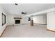 Bright basement featuring a stone fireplace, neutral carpet, and a support column at 6367 Arapahoe Ct, Parker, CO 80134