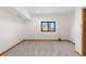 Neutral basement featuring plush carpet, trim, and a window providing natural light at 6367 Arapahoe Ct, Parker, CO 80134
