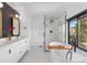 Modern bathroom with a soaking tub, a glass-enclosed shower, a double vanity, and black and gold accents at 6367 Arapahoe Ct, Parker, CO 80134