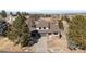 Inviting front exterior of home with an attached two car garage and a long driveway amid mature landscaping at 6367 Arapahoe Ct, Parker, CO 80134