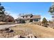 Charming brick and siding home with a three-car garage and a well-manicured front yard at 6367 Arapahoe Ct, Parker, CO 80134