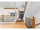 Entryway showing the staircase, hardwood floors, black iron railings, and lots of natural light at 6367 Arapahoe Ct, Parker, CO 80134