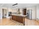 Beautiful kitchen featuring a large center island, granite counters, stainless steel appliances, and white cabinetry at 6367 Arapahoe Ct, Parker, CO 80134