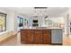 Bright, open kitchen featuring a granite island, stainless steel appliances, and hardwood floors at 6367 Arapahoe Ct, Parker, CO 80134