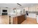 Bright kitchen featuring a granite island, stainless steel appliances, and hardwood floors at 6367 Arapahoe Ct, Parker, CO 80134