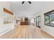 Bright living room blends seamlessly into a modern kitchen with light wood floors and high ceilings at 6367 Arapahoe Ct, Parker, CO 80134