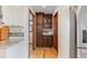 Convenient pantry with wooden cabinets, granite countertop, providing ample storage and prep space near kitchen at 6367 Arapahoe Ct, Parker, CO 80134