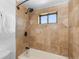 Shower featuring stylish tile surround, updated fixtures, and a built-in shower niche at 6367 Arapahoe Ct, Parker, CO 80134