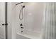 Bathroom with white tile surround, black shower head and bronze fixtures at 4089 Forever Cir, Castle Rock, CO 80109