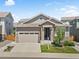 Charming single Gathering home featuring stone accents, a two-car garage, and manicured front lawn at 4089 Forever Cir, Castle Rock, CO 80109