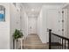 Bright hallway featuring hardwood floors, white walls, and paneled doors, leading to various rooms at 4089 Forever Cir, Castle Rock, CO 80109