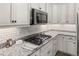 Well-appointed kitchen with sleek white cabinets, stainless steel appliances, and granite countertops at 4089 Forever Cir, Castle Rock, CO 80109