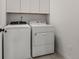 Laundry room featuring a Whirlpool washer and dryer, and white cabinets at 4089 Forever Cir, Castle Rock, CO 80109
