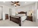 The main bedroom is adorned with an elegant, dark wood bed frame and bedside tables with lamps at 4089 Forever Cir, Castle Rock, CO 80109
