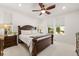 This main bedroom is spacious and bright and features a beautiful ceiling fan and views of the neighborhood at 4089 Forever Cir, Castle Rock, CO 80109