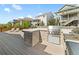 Relaxing deck showcases outdoor kitchen with bar seating, stainless steel grill, and lounge chairs at 4089 Forever Cir, Castle Rock, CO 80109