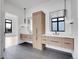 Bright bathroom features a double vanity, sleek countertops, modern fixtures, and dark tiled floors at 8132 Galileo Way, Littleton, CO 80125