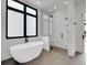 Luxurious bathroom features soaking tub, glass shower, and modern fixtures with natural light at 8132 Galileo Way, Littleton, CO 80125
