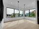 Bright dining area with oversized windows, hardwood floors, and modern chandelier at 8132 Galileo Way, Littleton, CO 80125