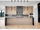 Bright, open kitchen features a large island with stone countertops and pendant lighting at 8132 Galileo Way, Littleton, CO 80125