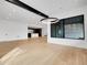 Spacious living room with hardwood floors, large window and modern lighting at 8132 Galileo Way, Littleton, CO 80125