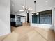 Spacious open-concept living and kitchen area with modern lighting and hardwood floors at 8132 Galileo Way, Littleton, CO 80125