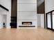 Open living room with modern gas fireplace, high ceilings, hardwood floors and unique design features at 8132 Galileo Way, Littleton, CO 80125