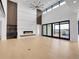 Open-concept living room boasts natural light, hardwood floors, and modern fireplace at 8132 Galileo Way, Littleton, CO 80125