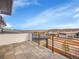 Balcony view overlooking the neighborhood with tile floor and black horizontal bar railing at 8132 Galileo Way, Littleton, CO 80125