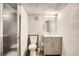 Bathroom featuring a modern vanity, a framed mirror, and a glass enclosed shower at 5265 Chandler Way, Denver, CO 80239