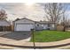 Charming single-story home with a manicured front yard and an attached garage at 5265 Chandler Way, Denver, CO 80239