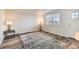 Bright living room featuring stylish wood-look floors and a large window at 5265 Chandler Way, Denver, CO 80239