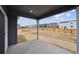 Covered patio overlooks a spacious, unfenced backyard, ready for landscaping at 1352 Orchard St, Brighton, CO 80601