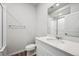Clean bathroom featuring modern fixtures, white vanity, sink, toilet, and shower/tub with glass doors at 1352 Orchard St, Brighton, CO 80601