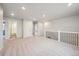 Large bonus room with neutral carpet and views of a staircase with modern black metal railings at 1352 Orchard St, Brighton, CO 80601