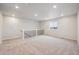 Spacious bonus room with neutral carpet, recessed lighting, and a staircase with modern black railings at 1352 Orchard St, Brighton, CO 80601