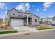 Beautiful two-story home with a two-car garage, complemented by green grass and simple landscaping at 1352 Orchard St, Brighton, CO 80601