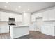 Modern kitchen featuring white cabinets, stainless steel appliances, and a central island at 1352 Orchard St, Brighton, CO 80601