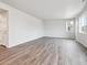 Bright living room featuring sleek wood floors and ample natural light from large windows at 1352 Orchard St, Brighton, CO 80601